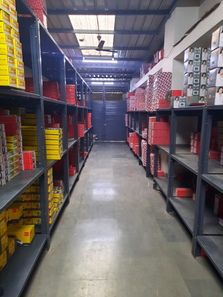 "GKSP Racking", Slotted angle racks Manufacturer in Bahadurgarh - Manufacturing slotted angle racks with GI panels from a decade. This rack has 7 feet height and is in dark grey color and have stored many types of boxes with electrical items/materials inside.