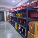 "GKSP Racking", Slotted angle racks Manufacturer- Manufacturing slotted angle racks with GI panels from a decade. This rack has 7 feet height and is in dark grey color and have stored many types of boxes with electrical items/materials inside.