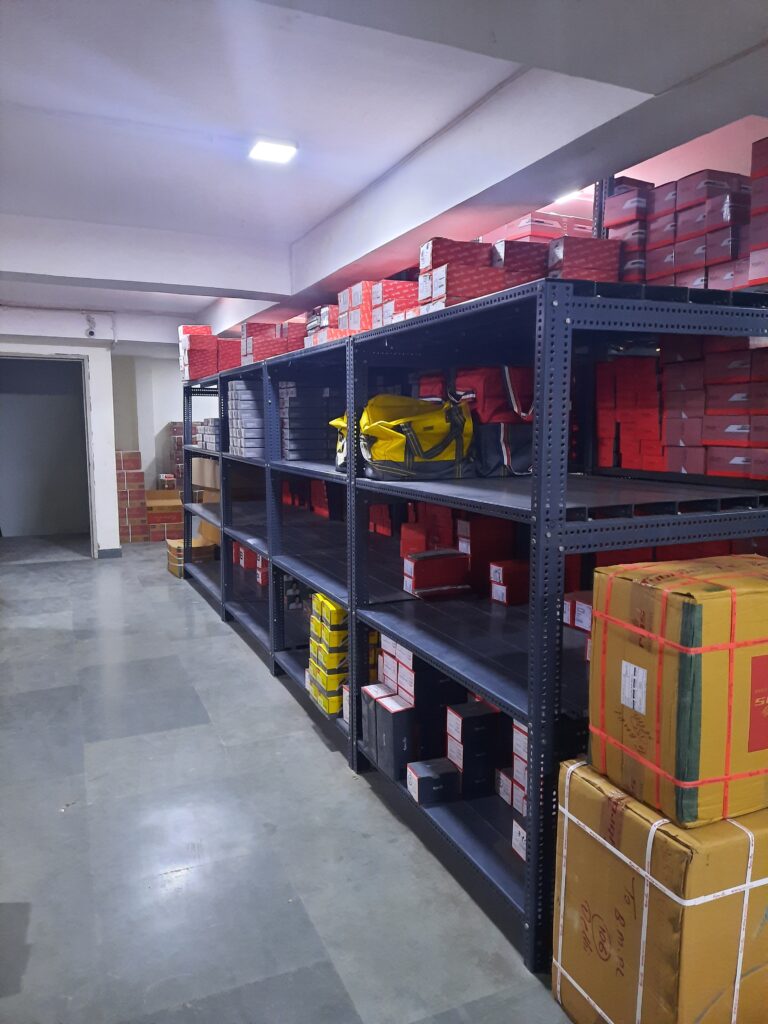 "GKSP Racking", Slotted angle racks Manufacturer in Bahadurgarh - Manufacturing slotted angle racks with GI panels from a decade. This rack has 7 feet height and is in dark grey color and have stored many types of boxes with electrical items/materials inside.